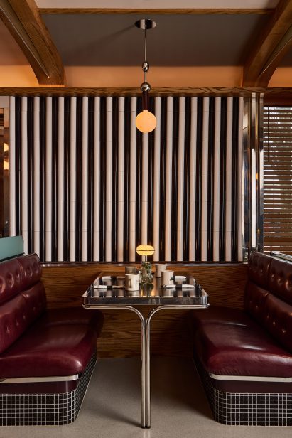 Dining Booth with chrome details on the table, seating and lighting