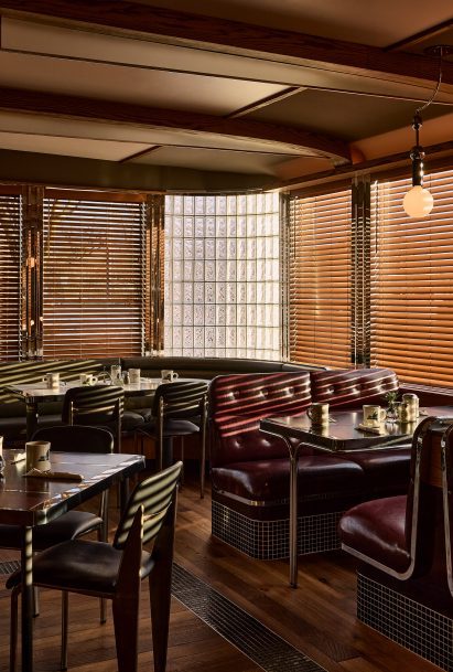 Restaurant interior with gently curved wooden ceiling beams and Venetian blinds 