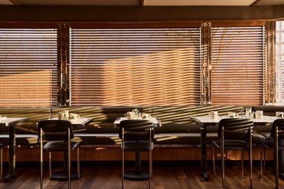 Venetian blinds over the windows of a restaurant
