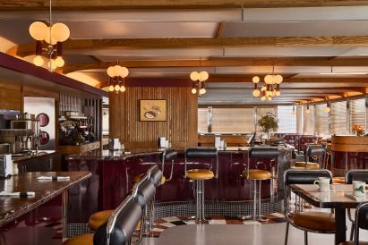 Renovated diner with chrome bar stools against a burgundy counter