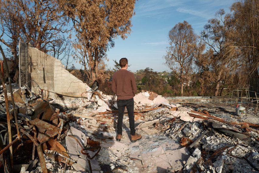Man standing on fire-destroyed house