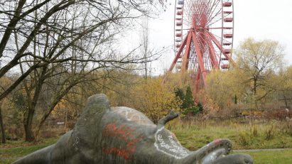 Fallen dinosaur statue