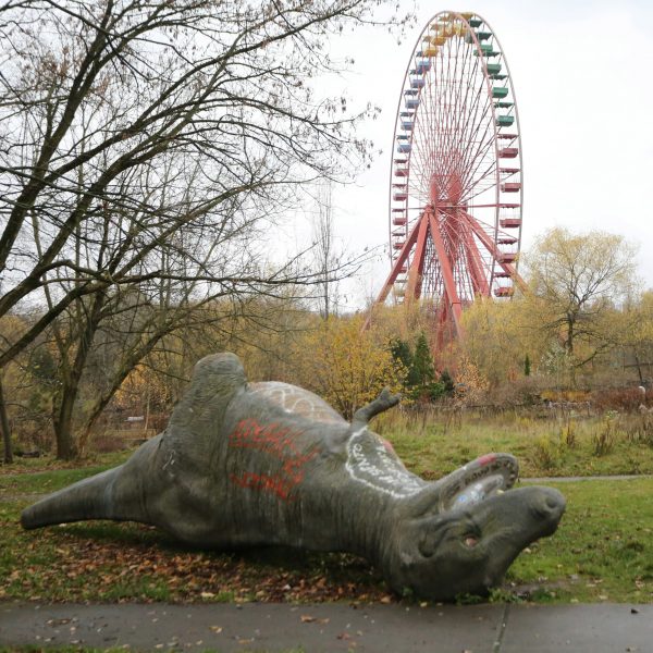 Fallen dinosaur statue