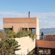 Board formed concrete house with mountains in the background
