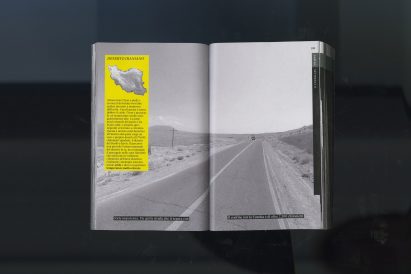 An image showing an open book with a black and white image of a road. Behind the book is a black and grey backdrop.