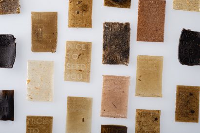 A photograph of multiple rectangular material swatches, in varying tones of beige and brown.