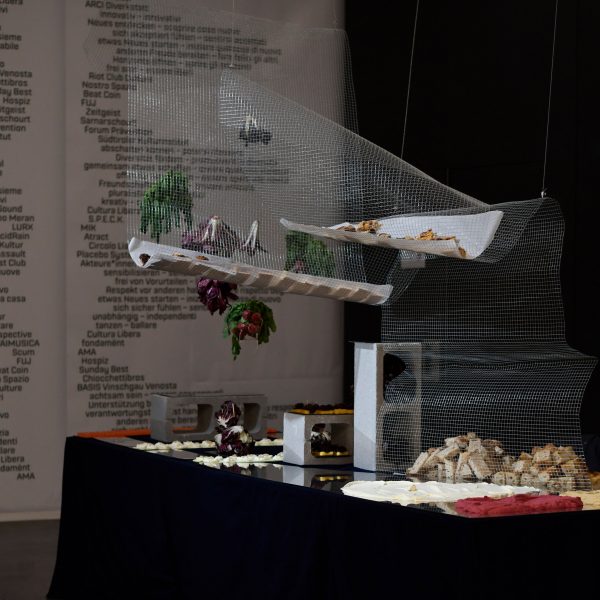 A photograph of an exhibition in dark tones.