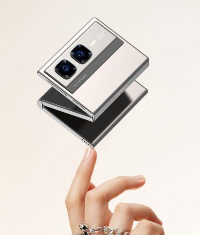 Rendering of the Infinix Zero Series Mini Tri-Fold phone hovering mid-fold over a person's fingertips