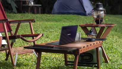 Image of the Lenovo Yoga Solar PC concept sitting on a wooden outdoor coffee table on a sunny lawn