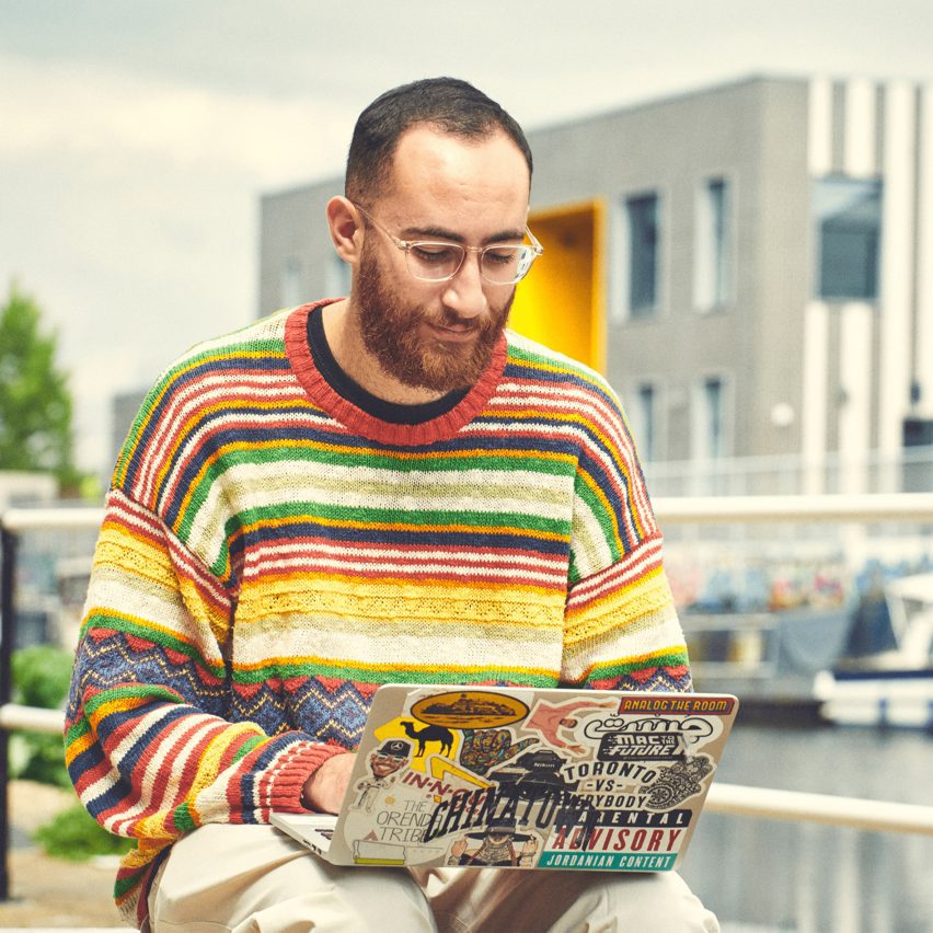 A photograph of a person using a laptop