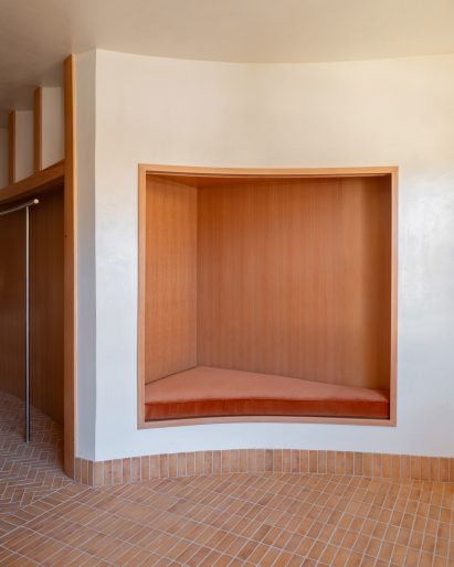 A wood-lined niche tucked into a curved wall