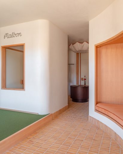 Store interior with a raised green-carpeted area at the front