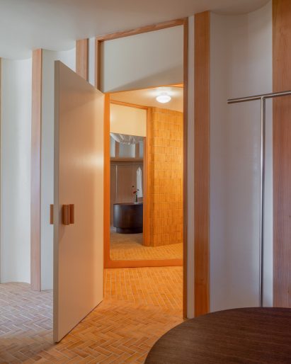 Terracotta-toned Zia floor tiles continue into a dressing room