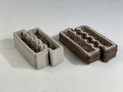 a photograph of models for plant pots, in tones of grey and brown