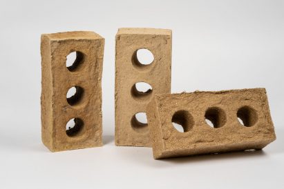 three brick prototypes in tones of brown, made from reed fibre