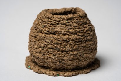 a photograph of a beehive protection prototype in tones of brown