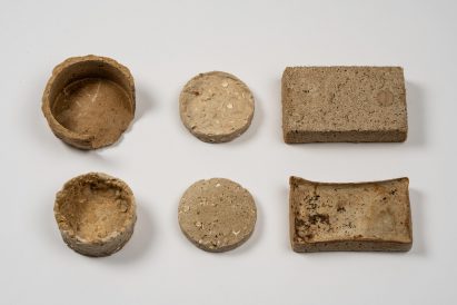 a photograph of circular and rectangular objects in tones of brown, showcasing material research