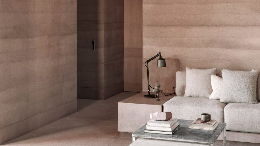 Living room with a rammed-earth wall