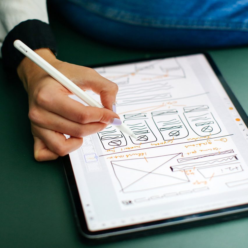 a person using a tablet with a stylus
