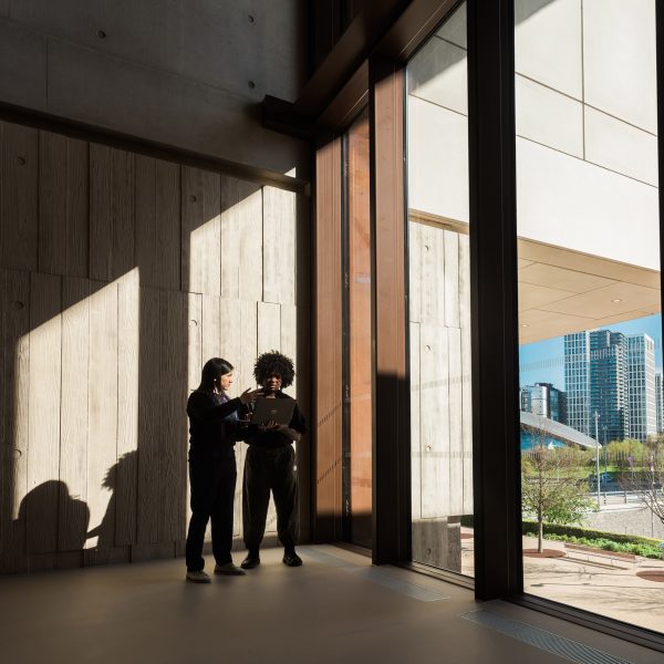 People standing next to windows inside a building