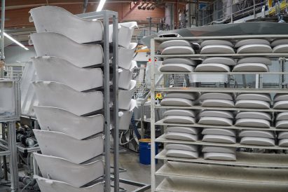 Photo of stacks of foam cushions arranged on racks in a factory