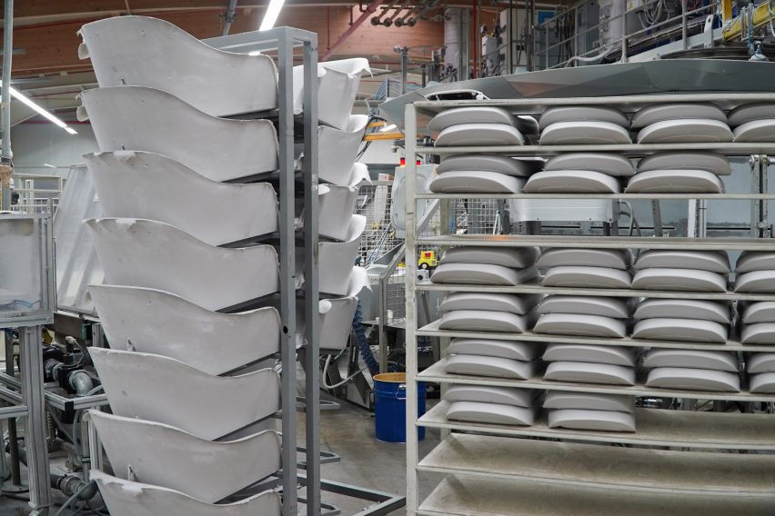 Photo of stacks of foam cushions arranged on racks in a factory