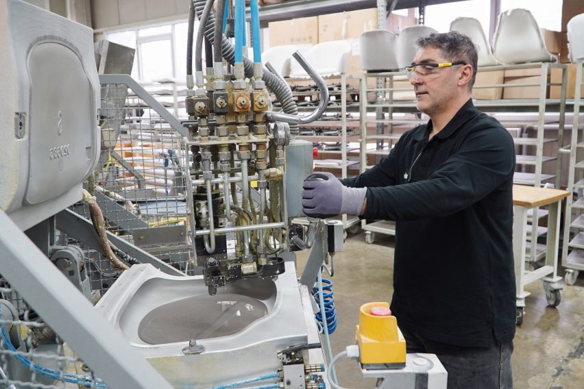 Photo of a man handling a machine injecting a grey substance into a mould in a factory