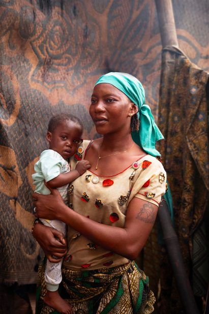 Portrait of Feti and her son in their backyard, Ilaje, Lagos