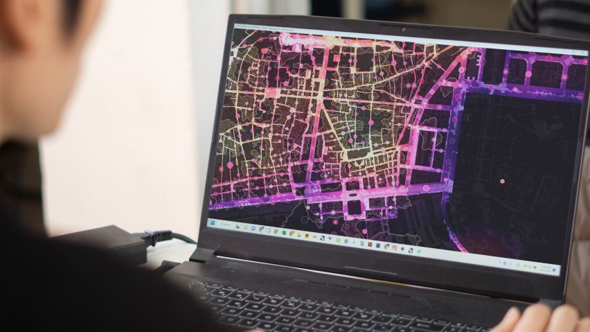 a photograph of a laptop displaying a pink and purple digital image