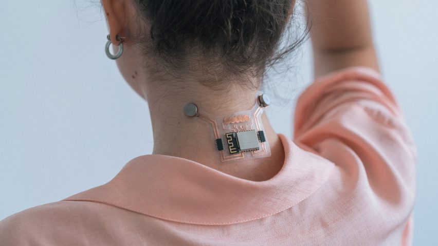 a photograph of a person wearing an electronic device on the back of their neck