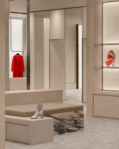 Volumes of micro-cement, leather and marble arranged into a seat and display