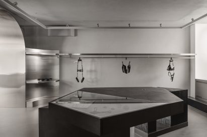 Leather lingerie displayed in a greyscale room