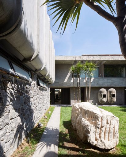 A house surrounded by stone walls