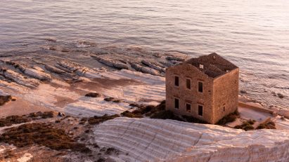 a photograph of a brick stone ruin on the coast