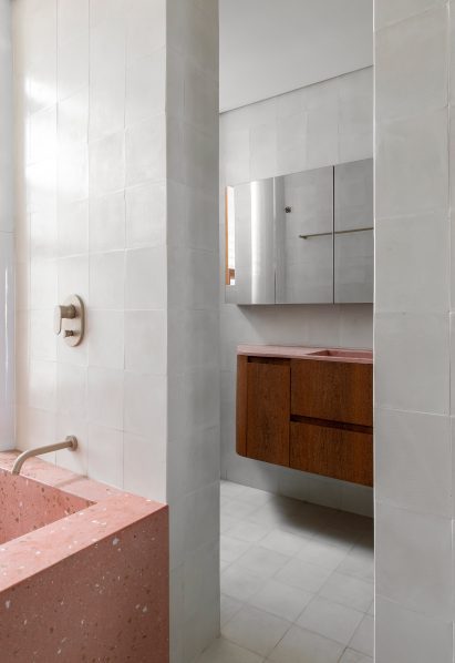 Bathroom with pink precast concrete bathtub and vanity counter