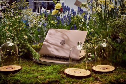 ASUS's Adol laptop surrounded by plants and flowers with scent jars