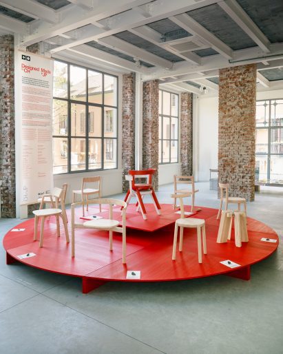 Wooden chairs on a red pedestal
