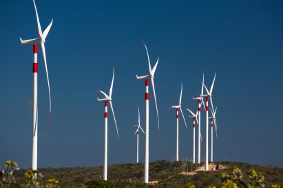 Row of turbines at a wind farm with red stripes