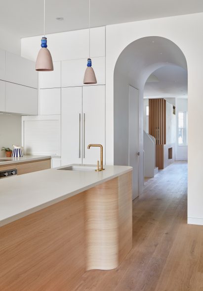 Ceramic pendant lights above a curved kitchen island