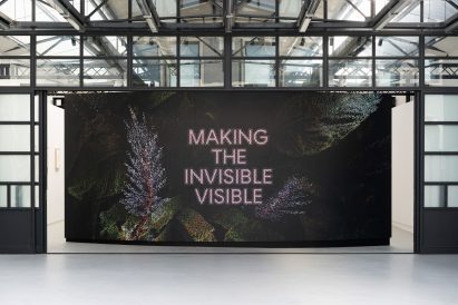 Photo to the entry of an exhibition reading 'Making the Invisible Visible'