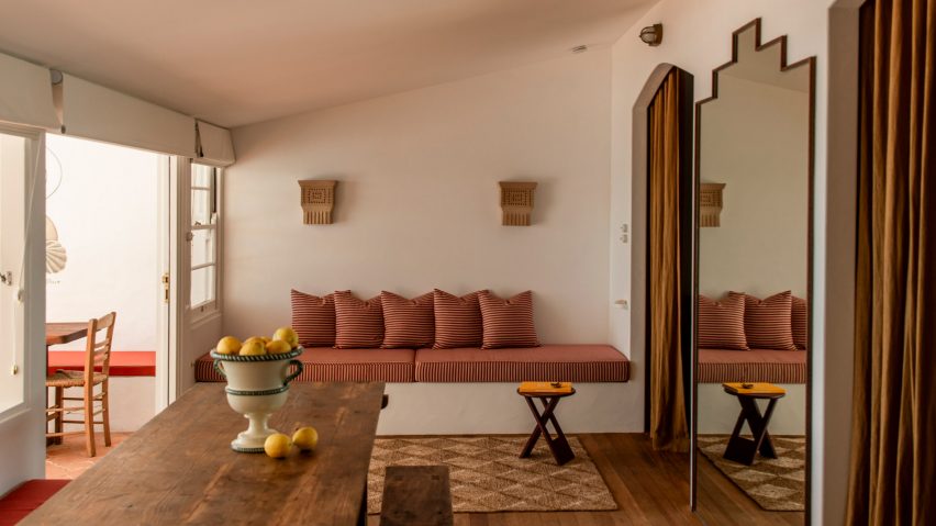 Interior with striped banquette and ceramic wall lights
