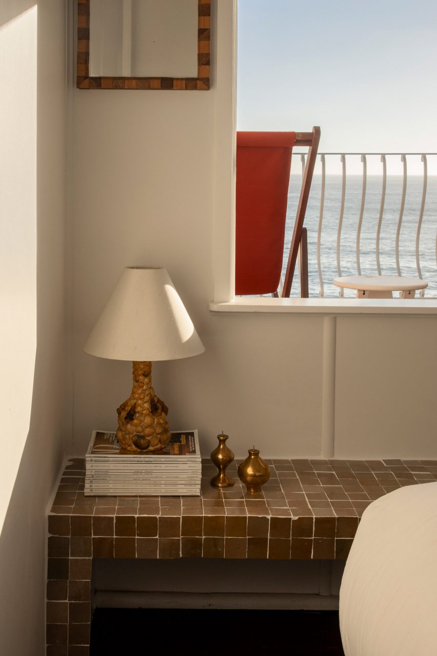 Bedside table with view of ocean and deckchair