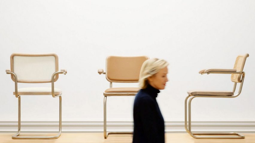 Fashion designer Jil Sander in front of chairs