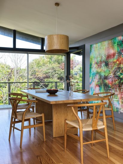 Dining room with wooden table and six modernist chairs