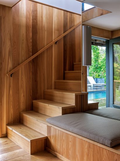 Wooden staircase with second tread extending to form a seat
