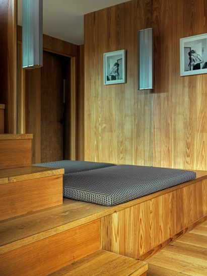 Cushion atop a wooden seat in front of a mirror