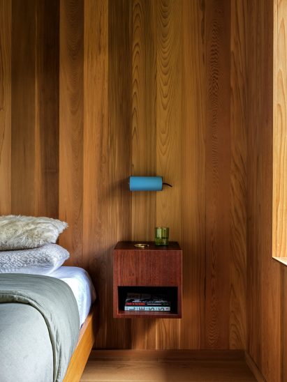 Blue sconce by Charlotte Perriand above a floating nightstand