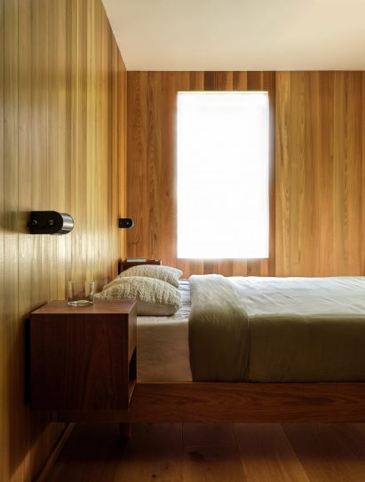 Cube-shaped custom nightstands flank a beds