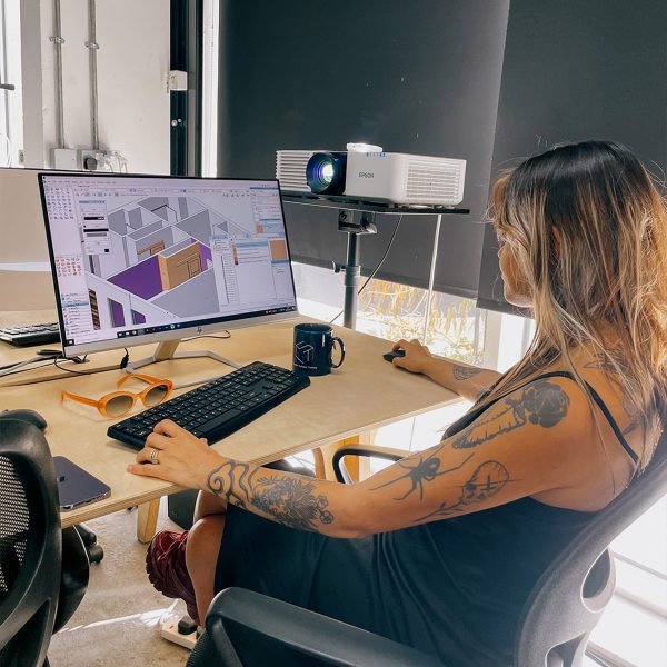 a photograph of a person sat at a desk using a computer