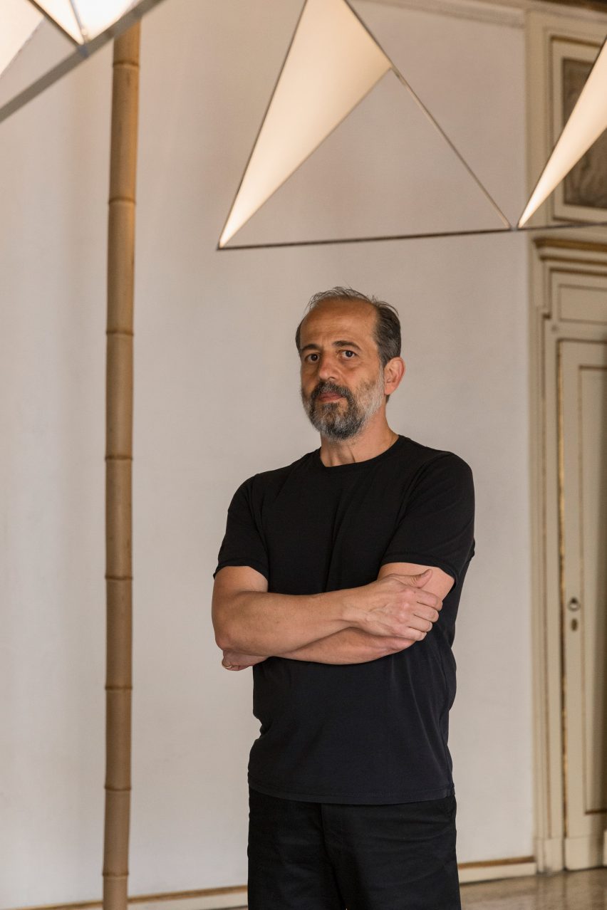 Designer Michael Anastassiades in front of his Cygnet light